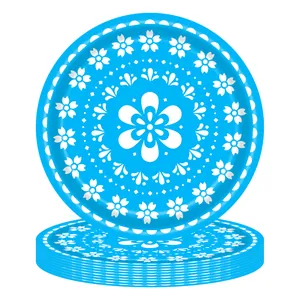 Detailed view of blue paper plates with white Mexican folk floral patterns.