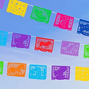 Vibrant Mexican Papel Picado flags hanging against a clear blue sky for party decor