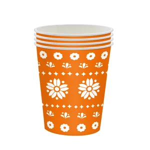Stack of vibrant orange paper cups featuring Mexican folk art floral patterns for parties