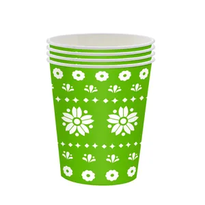 Detailed view of green disposable paper cups with Mexican Day of the Dead floral patterns