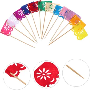 Detail view of colorful Mexican Day of the Dead felt flag cake toppers with floral patterns