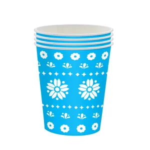 Detail view of blue disposable paper cups with white floral patterns for Mexican Day of the Dead
