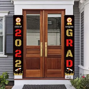 Detailed view of 2022 graduation porch banners on a house front door decoration