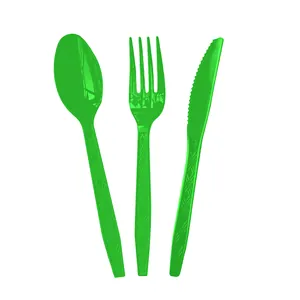 Close-up of green disposable plastic spoon, fork, and knife set for parties