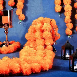 Close-up of vibrant orange artificial marigold flower garlands for festive home decor