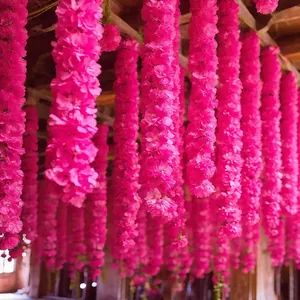 Close-up of vibrant pink synthetic marigold flower garlands for Indian wedding decor