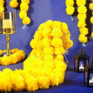 Detailed view of vibrant yellow artificial marigold flower garlands for festive decorations.