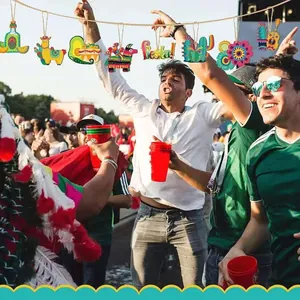 Colorful Mexican Fiesta wooden ornaments hanging in a festive outdoor carnival scene