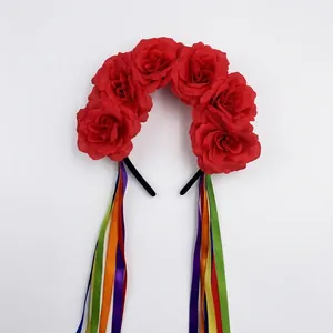 Detailed view of red fabric roses and vibrant satin ribbons on a festive headband