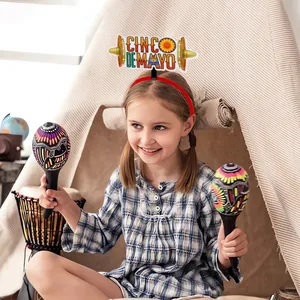 Caucasian child wearing a festive Cinco de Mayo headband with sombrero and colorful felt letters