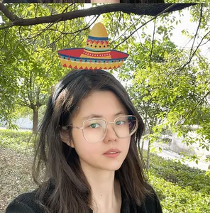 Asian model wearing colorful Mexican sombrero headband for Cinco de Mayo party celebration