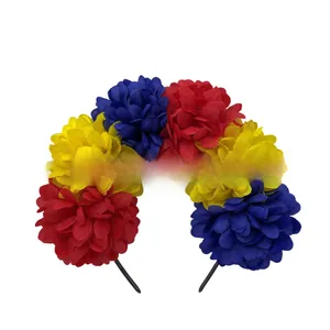 Detail of vibrant red, yellow and blue fabric flowers on Mexican carnival headband