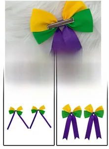 Detail view of Mardi Gras tricolor grosgrain bow hair clip with metal alligator fastener.