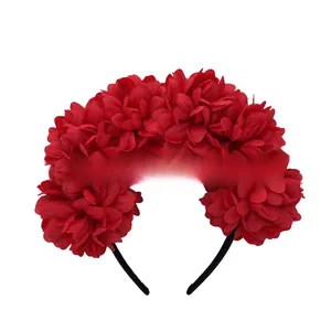 Detail view showing dense layers of red fabric flowers on a festival headband accessory