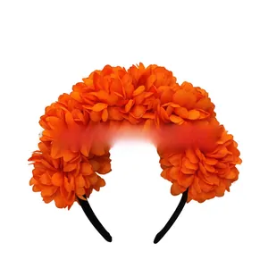 Detailed view of bright orange marigold floral headband for Day of the Dead costume decor