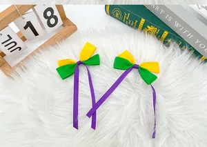 Close-up of vibrant purple green and yellow Mardi Gras ribbon bow hair clips for girls