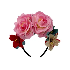 Detailed view of Mexican carnival floral headband with large pink roses and small red flowers