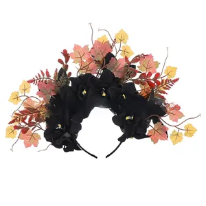 Detail showing black artificial flowers and colorful maple leaves on a Halloween headband.