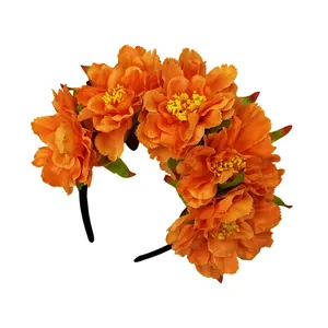 Detailed view of vibrant orange artificial peony flowers on a festive party headband.