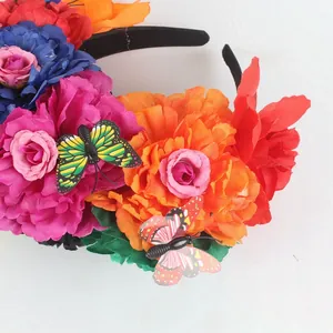 Close-up detail of Mexican Day of the Dead floral headband with vibrant peonies and butterflies