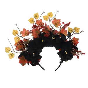 Close-up of Halloween floral headband with black flowers and autumn maple leaves