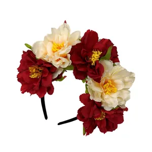 Close-up of large red and cream peony flowers on a black headband for festivals.