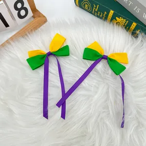 Handmade tricolor ribbon bow hair clips for Mardi Gras carnival in yellow, green and purple.