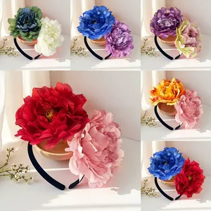 Detailed view of large 12cm artificial camellia headbands in multiple vibrant colors