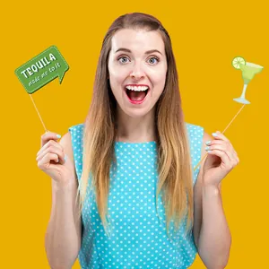 Model holding Mexican Fiesta photo booth props with Tequila theme