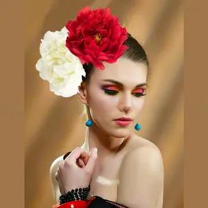 Close-up detail of oversized red and white camellia flower headband worn by a model