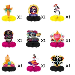Set of 9 Day of the Dead honeycomb centerpieces with various skull and floral designs.