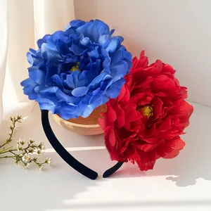 Detailed view of artificial camellia headband with 12cm red and blue flowers