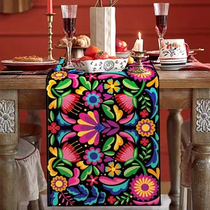 Detail of Dia De Los Muertos table runner with vibrant Mexican floral patterns.