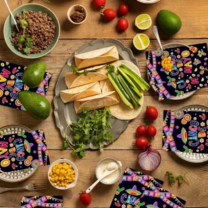 Festive Cinco de Mayo party napkins scattered among tacos and fresh ingredients on a wooden table