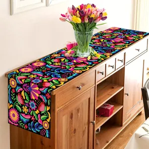 Vibrant Mexican Otomi floral table runner displayed on a wooden cabinet for party decor.