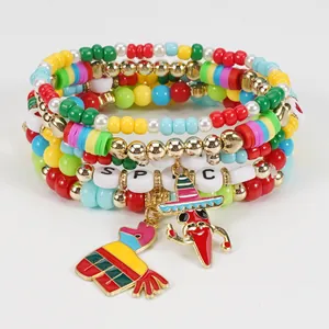 Detail view of Cinco de Mayo beaded bracelets with chili pepper and piñata charms.