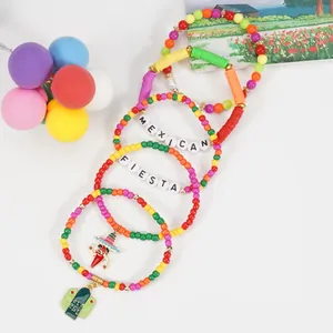 Detail view of colorful Mexican Fiesta beaded bracelets with chili and cactus charms.
