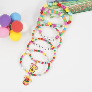 Detailed shot of Cinco de Mayo bracelets with spicy chili letters and avocado charms