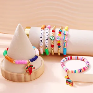 Detailed view of colorful Fiesta charm bracelets with chili and pinata pendants