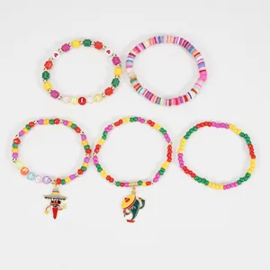 Detail view of colorful Cinco de Mayo boho bracelets with chili and cactus charms.
