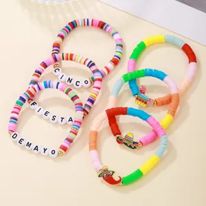 Close-up of vibrant Mexican fiesta clay bead bracelets with chili and sombrero charms.