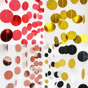 Detailed view of shimmering glitter paper circle garlands in red, gold, and black.