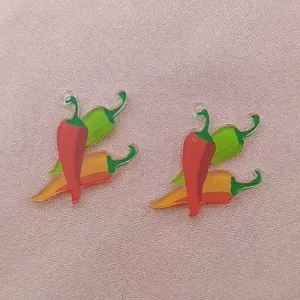 Detailed view of colorful chili pepper acrylic charms for Mexican carnival jewelry.