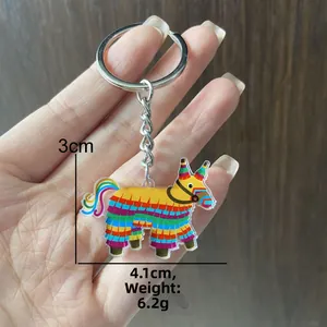 Detailed close-up of a colorful llama piñata keychain showing size dimensions and weight