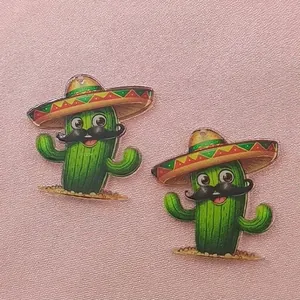 Close-up of acrylic Mexican carnival cactus charms with sombrero and moustache