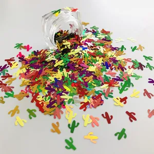 Macro detail of colorful cactus-shaped glitter confetti spilling from a clear jar