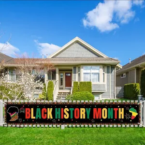 Large Black History Month banner displayed on an outdoor lawn in front of a house