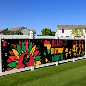 Detailed view of a Black History Month themed outdoor banner on a white garden fence.