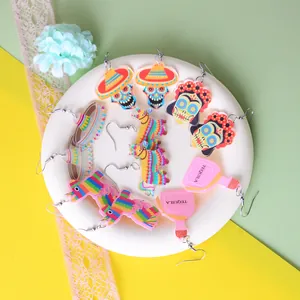Various colorful Mexican Fiesta themed acrylic earrings featuring skull and pinata designs.
