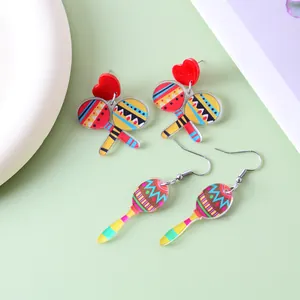 Detailed view showing colorful Mexican fiesta maracas earrings with red heart studs